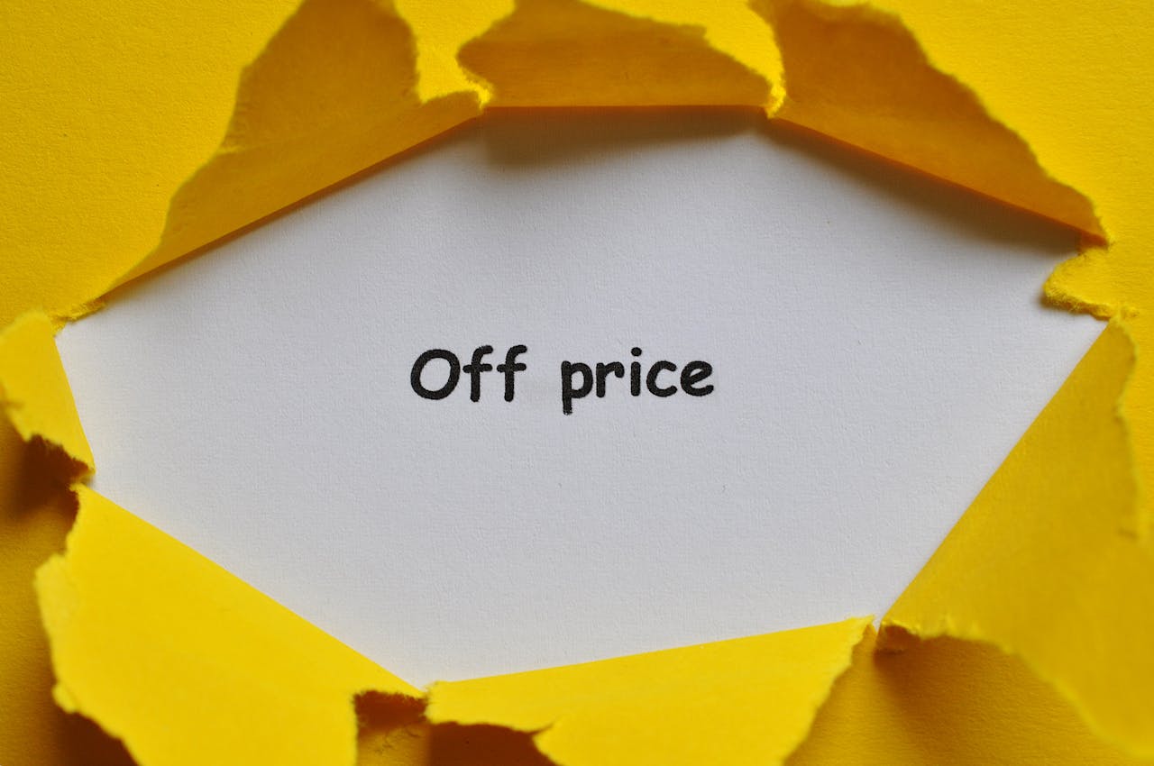 Yellow paper torn open to reveal Off Price text, perfect for sales and discounts concept.